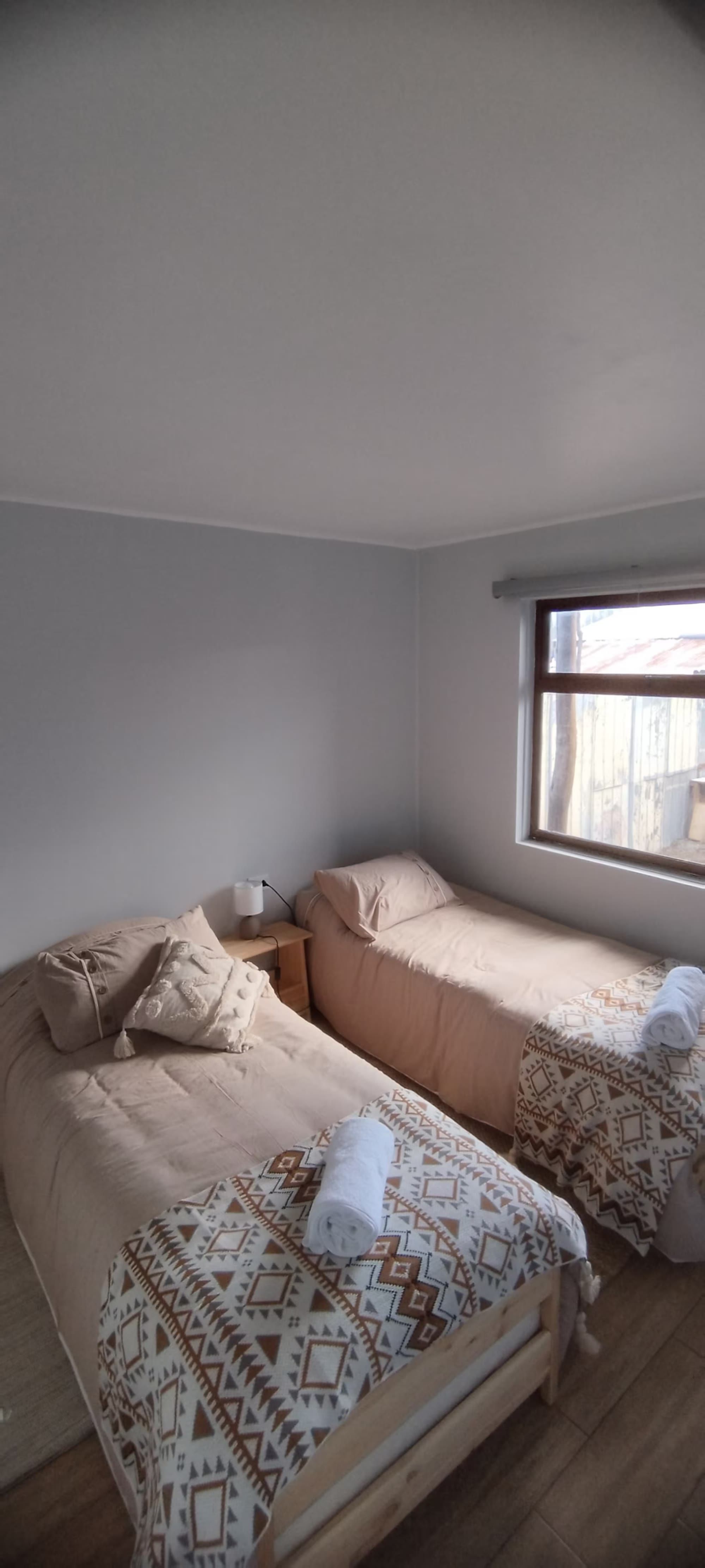El segundo dormitorio, con camas individuales y ventana al patio